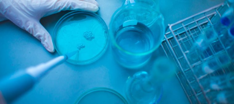 cropped-image-scientist-experimenting-blue-chemical-laboratory