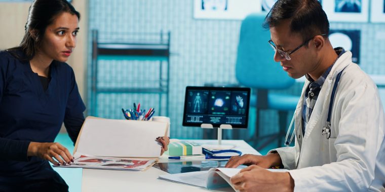 Physician meeting with a patient to discuss medical test results in a cabinet, using advanced diagnostic tools to interpret x ray scans, demonstrating a professional healthcare approach. Camera A.